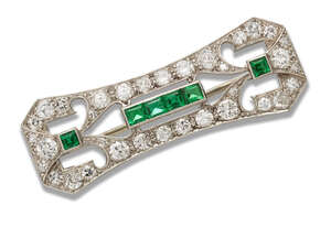 
	
		A diamond and emerald panel brooch, the pierced rectangular panel set with brilliant and...