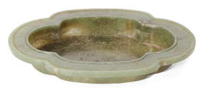 
	
		A Chinese spinach jade quatrefoil dish, late Qing dynasty, with flattened grooved rim and...