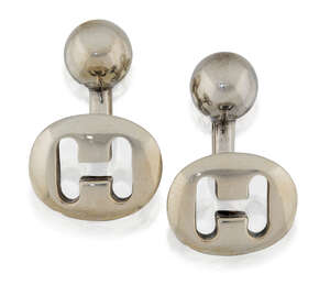 
	
		A pair of silver cufflinks, by Hermes, designed as oval lozenges pierced with the letter...