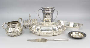 
	
		A quantity of silver plate, to include a pair of silver plated on copper tapering...
