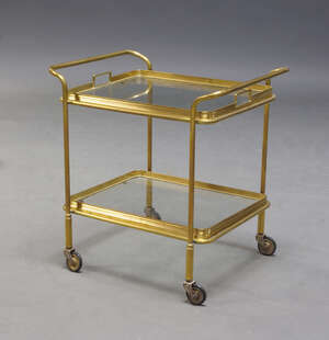 
	
		An Italian brass and glass two tier trolley, c. 1950, with two removable glass trays, on...