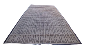 A very large modern woven rattan carpet with Greek key motif design, designed by Roger Jones at...