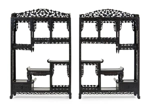 A pair of Chinese hongmu display stands, last quarter 19th century, profusely carved with...