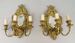 
	
		A pair of Dutch taste gilt metal three light girandoles, late 19th/early 20th century, ...