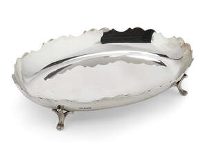A George VI silver dish, Sheffield, c.1939, Viner's Ltd., of oval form with scalloped edges to flat base raised on four feet, 23cm dia., approx. weight 12o