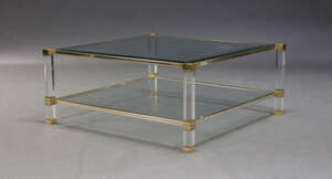 
	
		Pierre Vandel, a gilt metal and perspex two tier coffee table, c.1980, the square glazed...