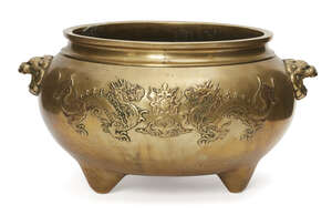 
	
		A large Chinese polished bronze tripod censer, late Qing dynasty, decorated in relief...