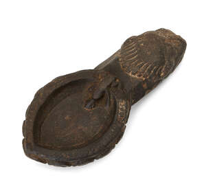 
	
		A stone lamp, possibly Java, 11th-12th century or later, in the form of a recumbent sea...