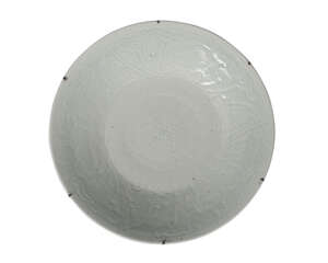 A large Chinese porcelain celadon charger, early 19th century, carved to the central reserve with a flowerhead, surrounded by a border of flowering lotus scrol