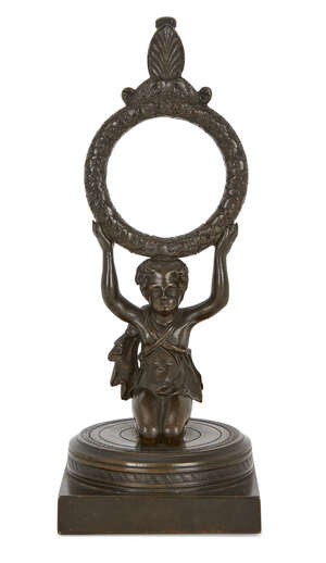 
	
		A Regency bronze figural pocket watch stand, early 19th century, modelled as a kneeling...
