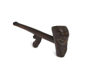 
	
		A tribal hardwood pipe, Yorouba, Nigéria, the curved bowl carved with a peaceful male...
