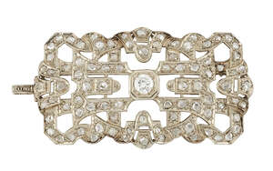 An Art Deco style diamond plaque brooch, the rectangular openwork panel set in the centre with an a circular-cut diamond,  within rose-cut diamond ribbon and g