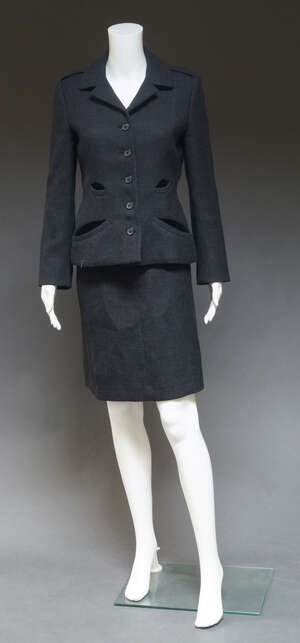 
	
		Prada, a grey wool jacket and skirt suit, the short fitted jacket with four pockets, with...