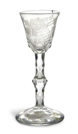 
	
		A George III cordial glass, the tapering conical bowl engraved with flowers and grapes...
