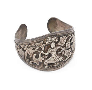 
	
		A silver cuff bracelet with warrior, Myanmar, early 20th century, the band widening to...
