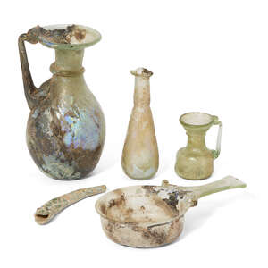 
	
		Four Roman glass vessels, circa 2nd-4th Century A.D.
		
		Including a small pale green...