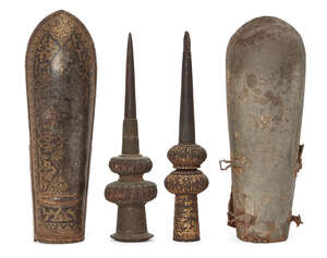 
	
		Two Mughal steel arm guards or bazubands, one of damascened gold, and two spear butts,...