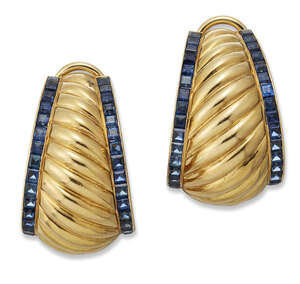 
	
		A pair of continental, sapphire ear clips, each designed as a tapering scroll candy...