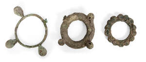 Three large Chinese bronze bracelets, Neolithic period, each cast with spherical knops, 9cm -...