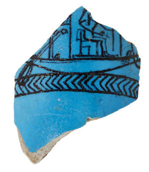 An Egyptian bright blue glazed composition vessel fragment, New Kingdom, circa 1400 B.C., the outer curved wall section decorated with details in black showing