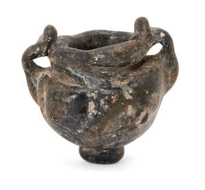
	
		A rod-formed bulbous dark green glass jar, Eastern Empire, 4th-5th century, with applied...