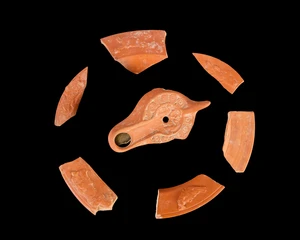 A fragmentary Roman African Red Slipware lamp decorated with two swans, 11.6cm long, and six...