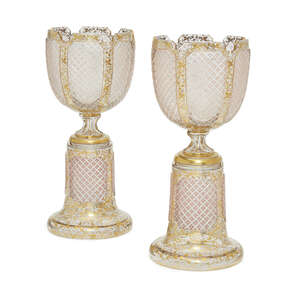 
	
		A pair of Bohemian cut and gilt glass urns on stands, late 19th/early 20th century, the...