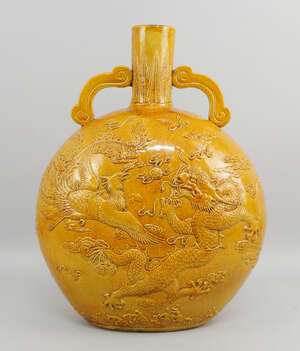 A Chinese yellow glazed porcelain moon flask, late 20th/early 21st century, moulded to both...