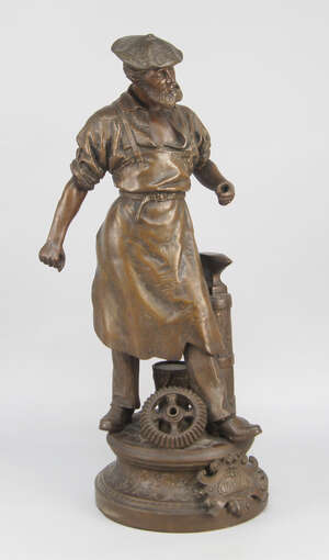 
	
		A French bronzed spelter figure of Industry, depicted as a bearded man wearing an apron....