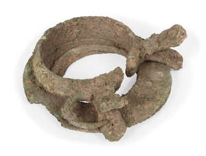 Two Chinese bronze bracelets, Neolithic period, now fused as one, 9cm diameter
 
 