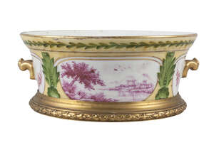 A Sevres style porcelain bowl , late 19th/20th century, decorated with panels of landscapes in puce, within green stiff leaf designs,on yellow grounds, with a 
