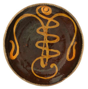 
	
		Bernard Leach attributed (1887-1979), a large slipware dish
		c.1930, impressed pottery...