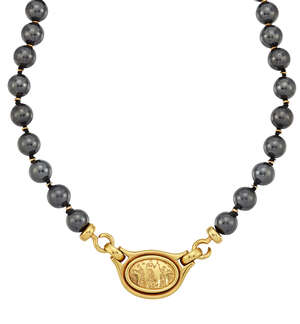 
	
		A haematite necklace with panel clasp, by Lalaounis, with central oval medallion...