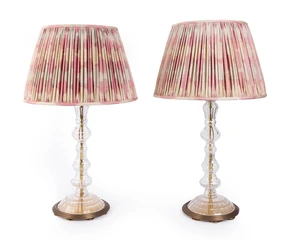 A pair of modern twin-light 'Crystal and Gilt' table lamps, by Sibyl Colefax & John Fowler, each with faceted stem with everted rim on stepped brass base, with