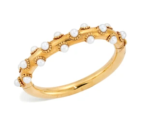 A cultured pearl bangle, of round section, oval, hinged form, the upper half with scattered...