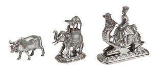 
	
		A figure mounted on a camel, an elephant with howdah and a figure of a bull, India, late...