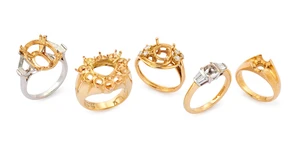 A group of five ring mounts, comprising: one of 18ct gold, London hallmarks, with baguette...