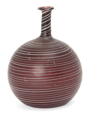 A Phoenecian trailed aubergine glass flask, 2nd-3rd century AD, of bottle for, with tall thin neck and everted rim, intact 7.5cm. high
		 
		Provenance: Pri