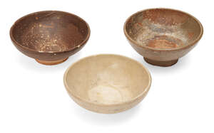 
	
		Three Chinese stoneware bowls, Yuan/Ming dynasty, all of shallow form, one with a celadon...