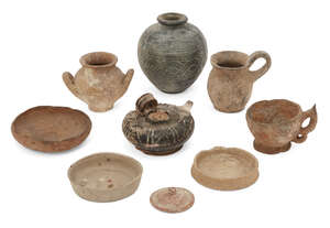 A group of ancient pottery vessels, 1st Millennium BC. and later, including a Greek black glazed oil lamp, 6.5cm high; a spherical buff pottery vessel with fla