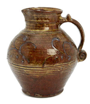 
	
		Michael Cardew attributed (1901-1983), a slipware jug
		c.1930, Winchcombe Pottery mark...