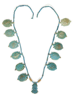 
	
		An Egyptian blue glazed faience lotus flower necklace 
		Amarna Period, mid-14th Century...