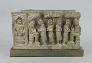 
	
		A Gandharan taste schist frieze depicting two seated princes being served by four...