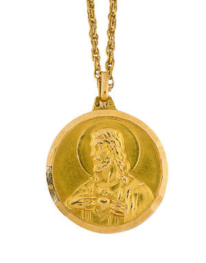 A 20th century religious medallion pendant and chain, the medallion depicting a raised image of Christ on one side and the Madonna and infant Christ on the oth