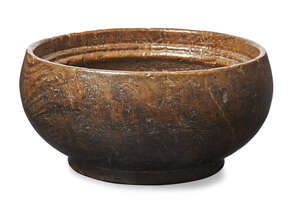 
	
		An English burr treen dairy bowl, 19th century, with inverted moulded rim, 10.5cm high,...