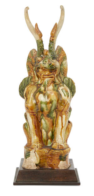 
	
		A Chinese sancai pottery figure of an Earth spirit, Tang dynasty, the seated figure with...