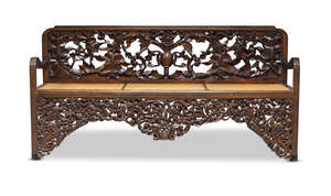 
	
		A Thai hardwood cane seated bench, early 20th century, the back and apron profusely...