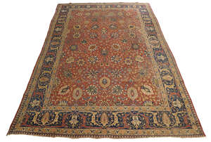 
	
		A Persian Tabriz carpet, third quarter 20th century, central floral motifs on a rouge...