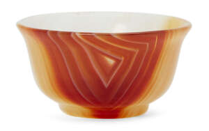 
	
		A small carved agate bowl, India or Iran, 19th/20th century, on a short foot, with flared...