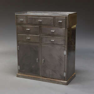
	
		An industrial steel cabinet, c.1950, with an arrangement of seven drawers and two...